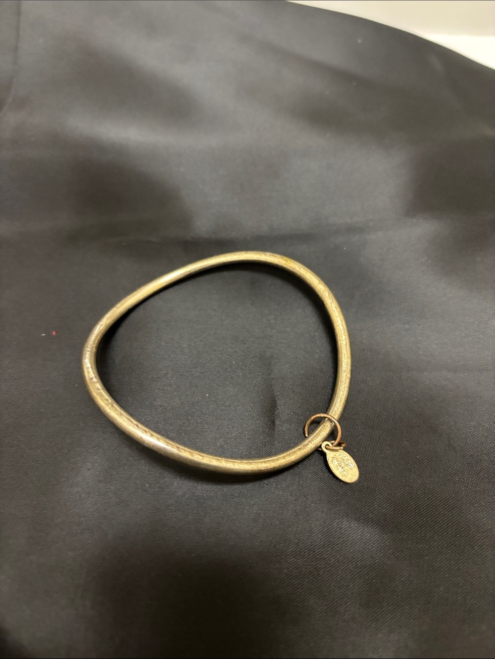 Gold-Tone Hammered Circle Bangle Bracelet with Dangling Tag